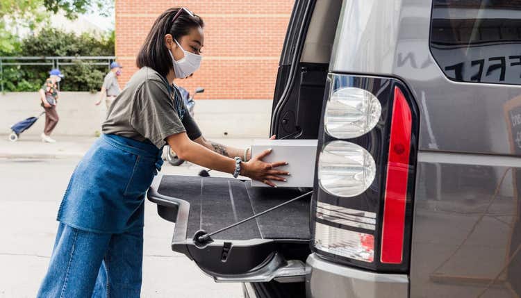 Woman in mask during curbside pickup