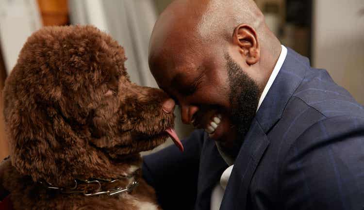 Dog licking man's face