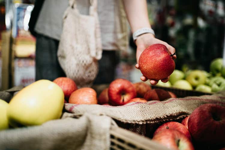 Person holding a red apple