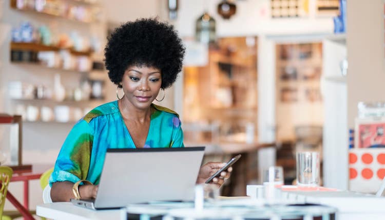 Woman on laptop in shop
