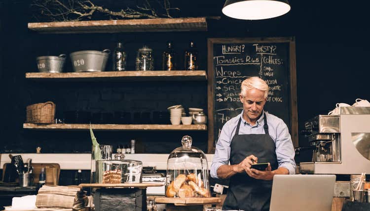 Restaurant owner using calculator