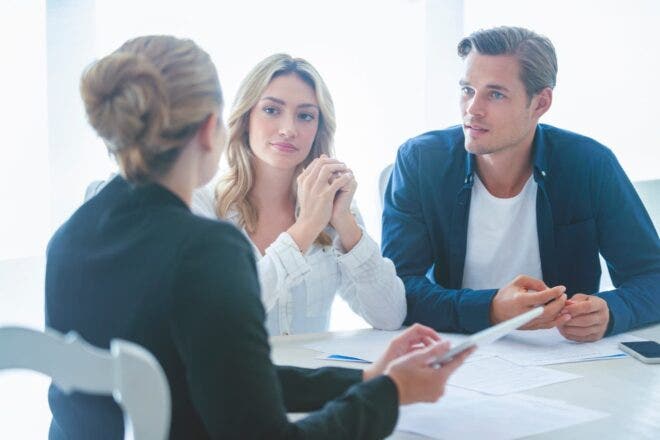 Attorney going through paperwork with couple