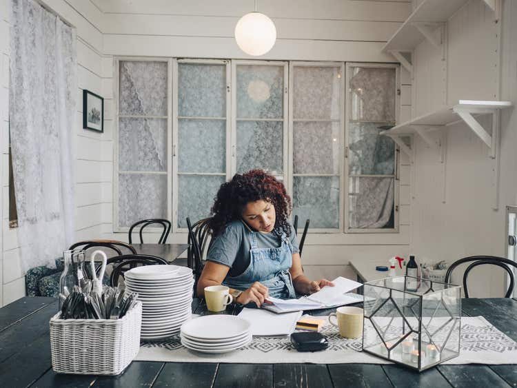Woman on phone planning for restaurant startup costs