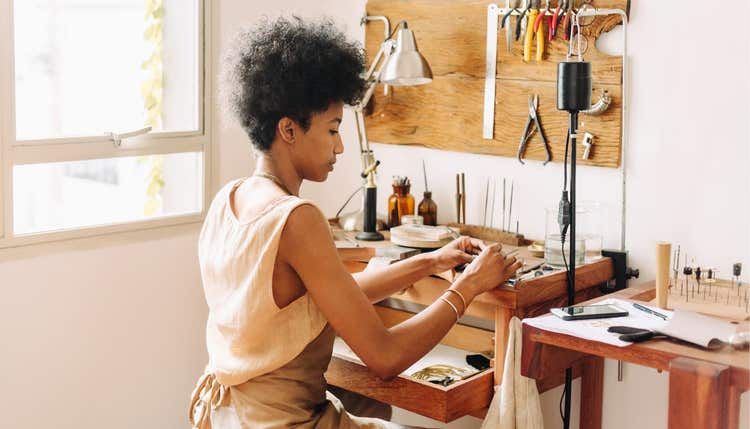 Woman making jewelry in workshop