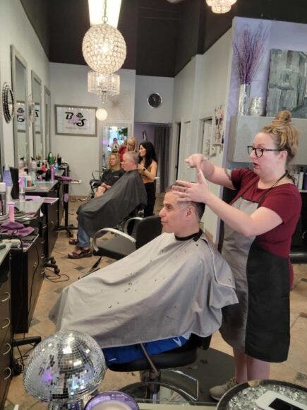 Stylists cutting clients' hair at Boardroom Hairstylists in Atlanta, GA
