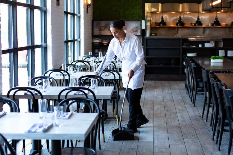 waitress sweeping in restaurant