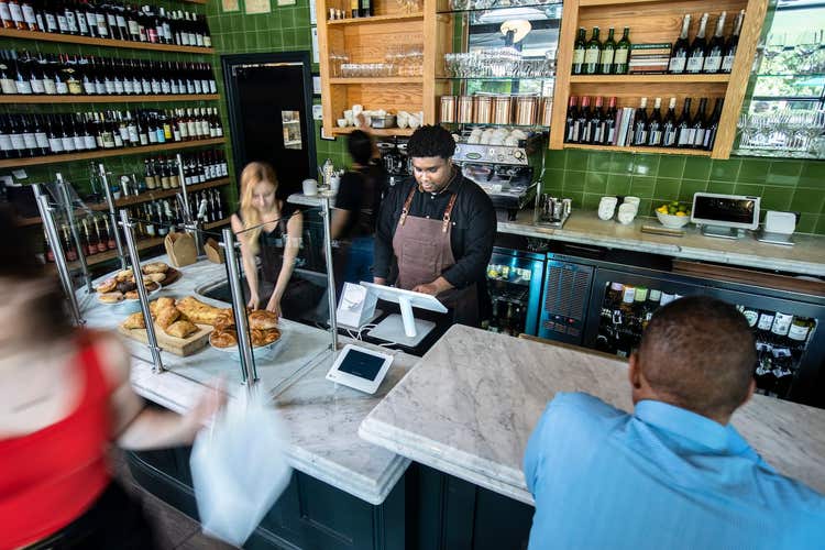 Staff working behind bar at cafe