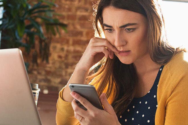 Concerned woman looking at phone