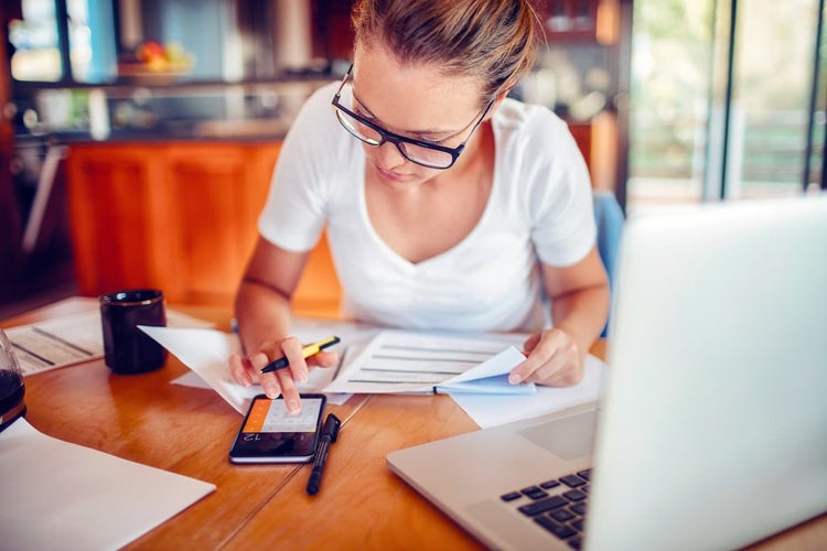 Woman using calculator on phone