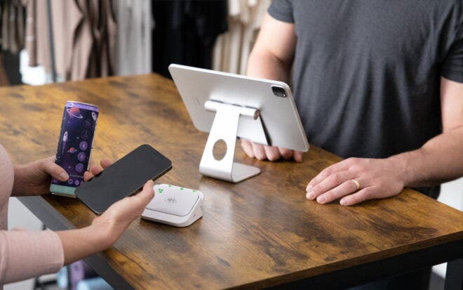Shopkeeper completing sales transaction with Clover Go