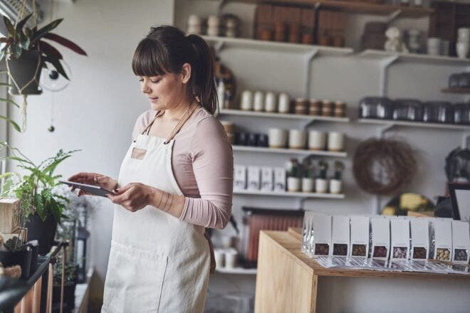 Retail shop owner looking at tablet