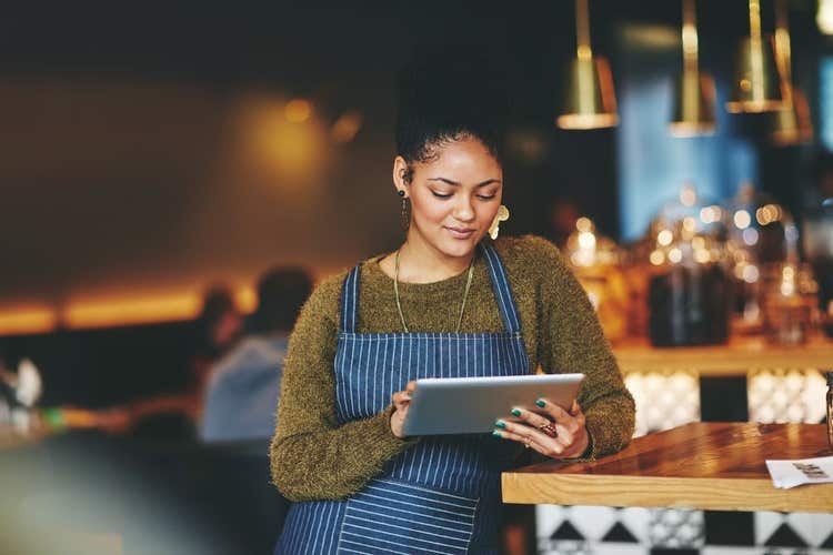 Restaurant manager looking at tablet