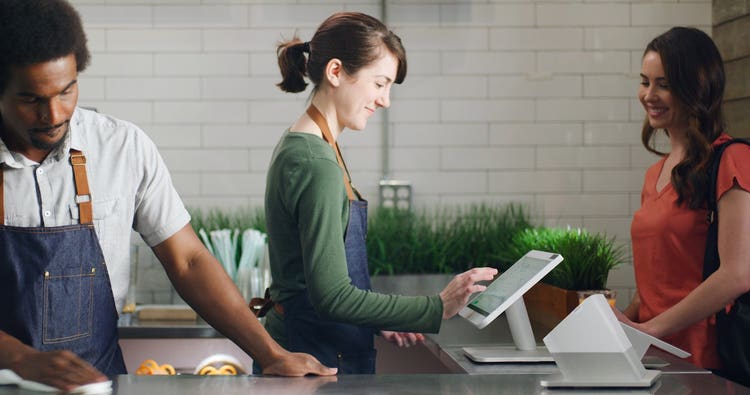 Woman using Clover Station POS
