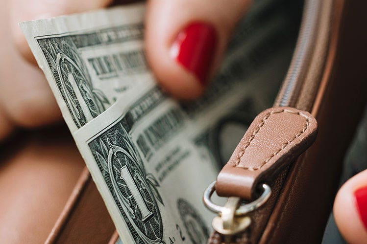 Dollar bills in wallet