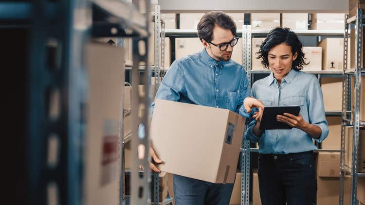 Two people looking at safety stock on tablet