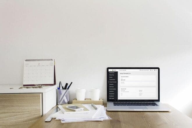 Desk with laptop and Clover Virtual Terminal interface