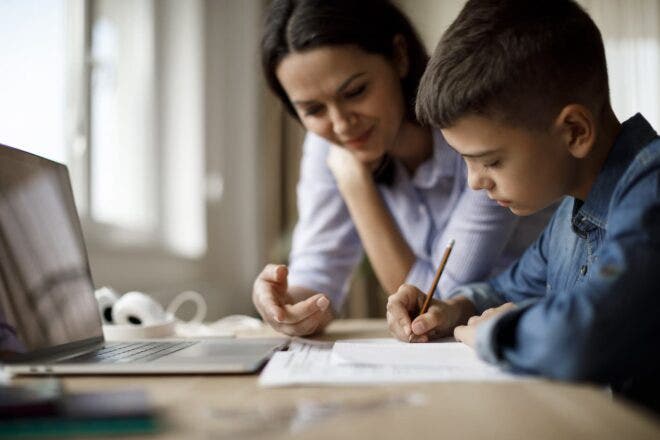 Woman tutoring boy