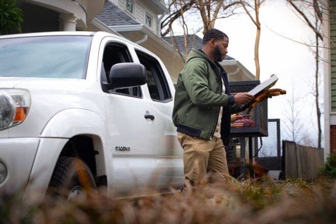 Landscaper looking at clipboard