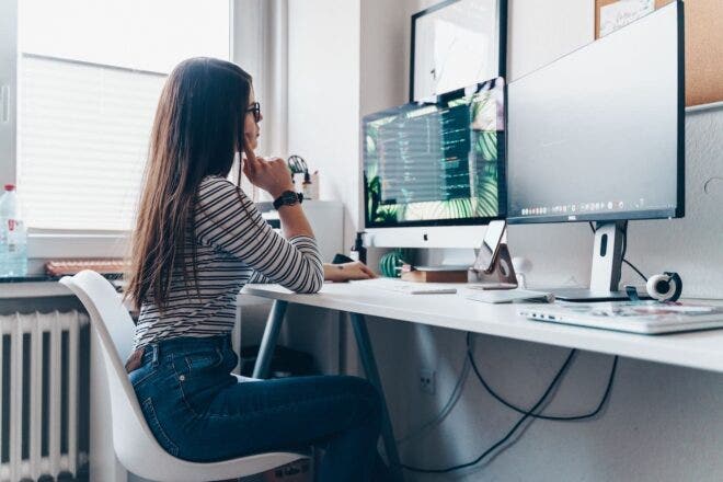 Woman in front of computer screens