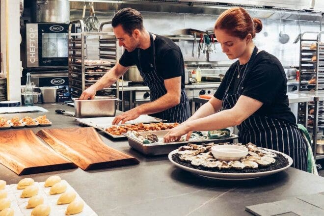 Chef and sous chef preparing food in a restaurant kitchen