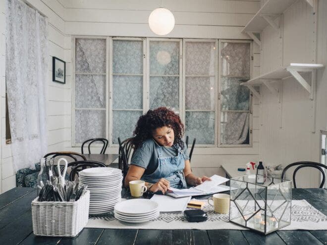Woman on phone planning for restaurant startup costs
