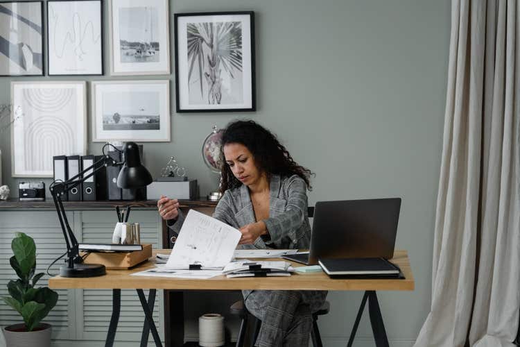 Woman looking through paperwork on desk
