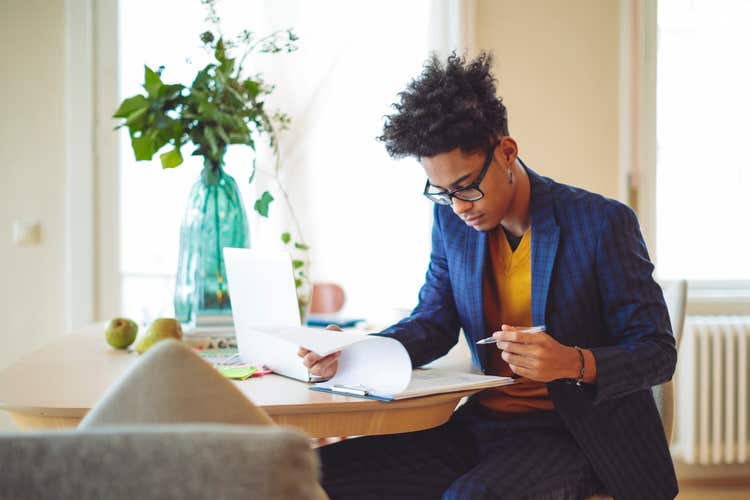 Man reviewing paperwork on clipboard