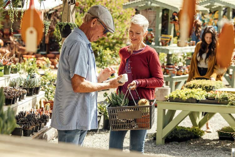 Plant shop owner assisting customer with Clover Flex