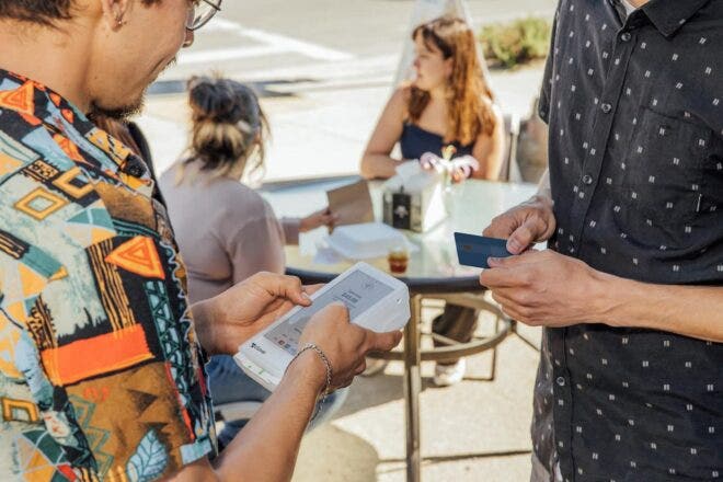 Person paying with debit card using Clover Flex