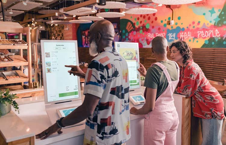 Customers placing orders at Clover Kiosk