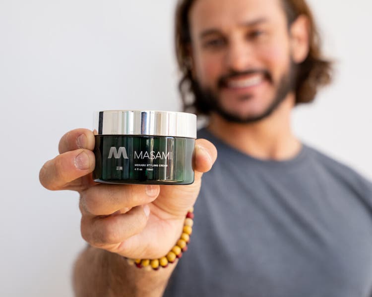 Man holding a jar of MASAMI product