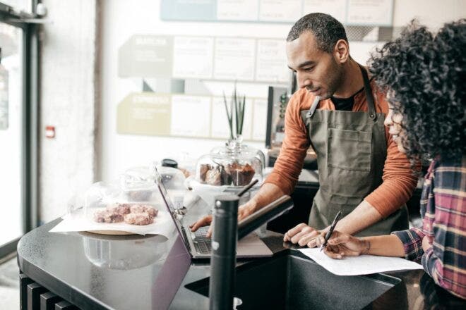 Restaurant workers looking at laptop
