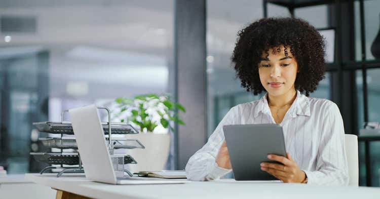 Professional woman working on tablet at desk