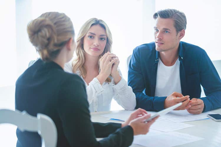 Attorney going through paperwork with couple