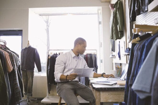 Man looking at laptop in retail store