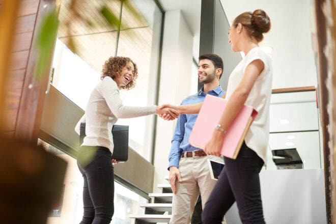 Three people shaking hands