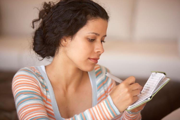 Woman writing in checkbook