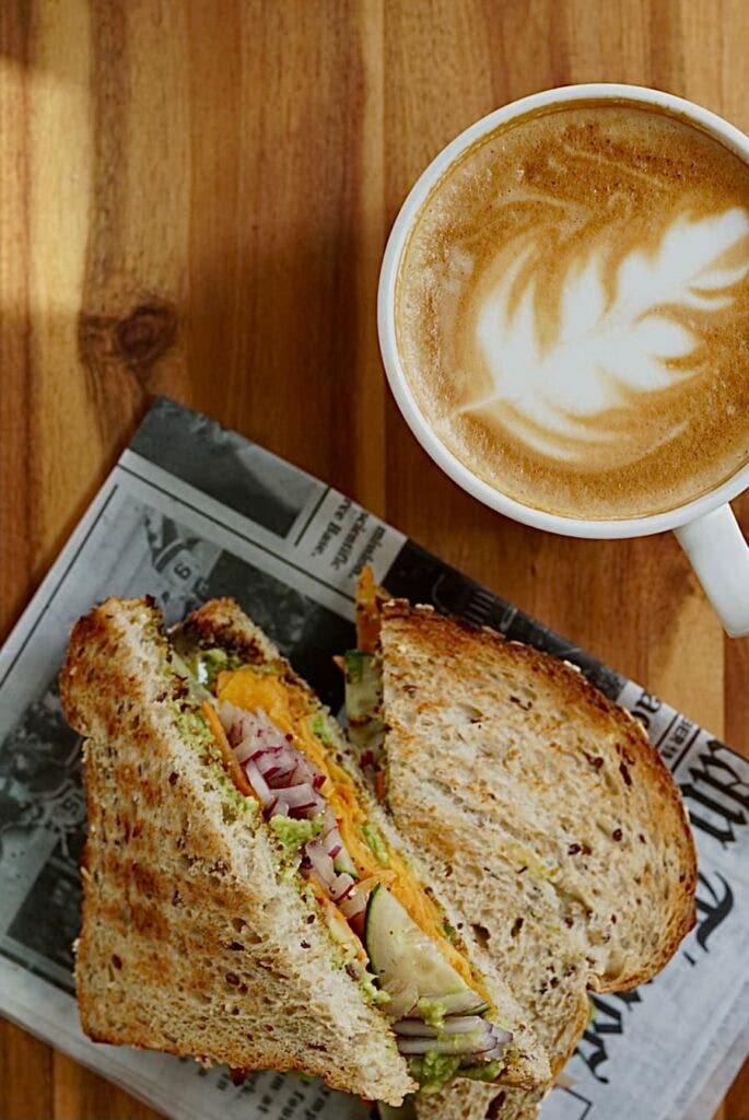 sandwich and cappuccino on table at winfield street coffee