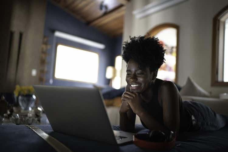 Woman watching show on laptop