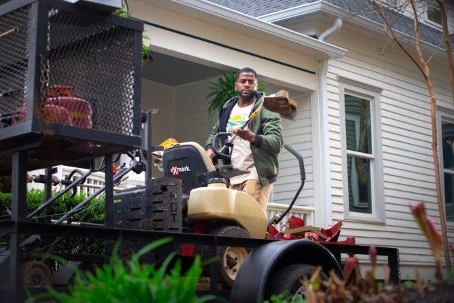 Landscaper holding weed trimmer