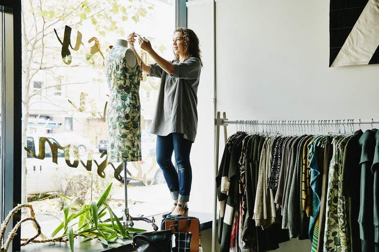 Woman dressing clothing form at boutique