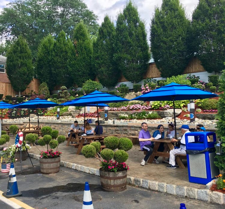 People eating ice cream on picnic benches