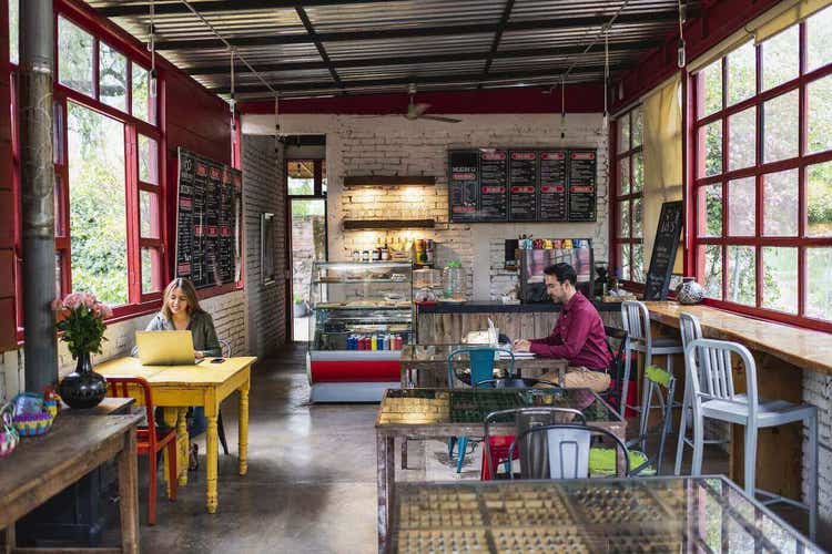 two-people-remote-working-at-cafe