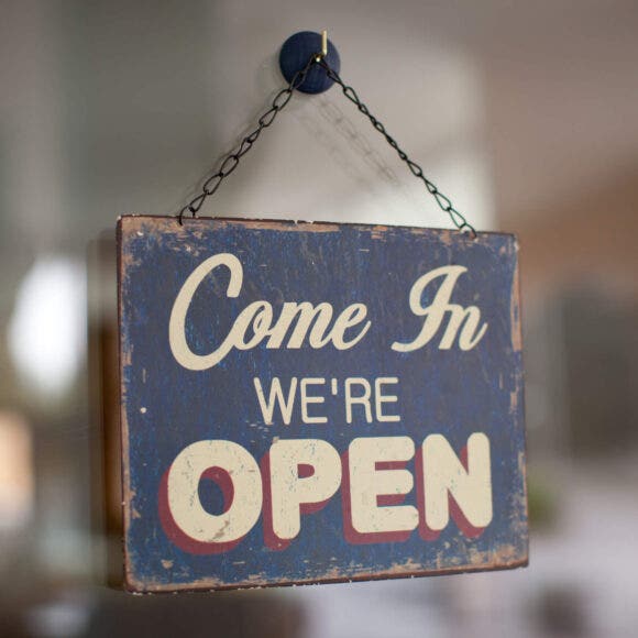 We're Open hanging sign