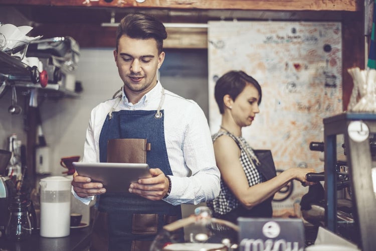 Two baristas in cafe