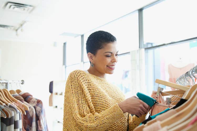 retail owner scanning clothing with barcode scanner