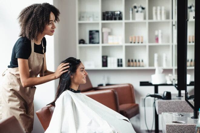 Salon stylist consulting with client in chair