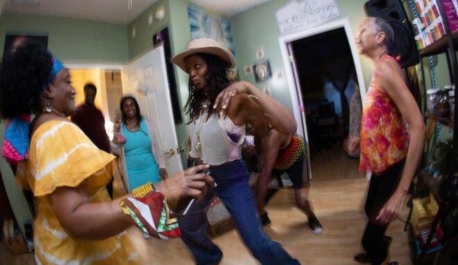 Owner of Sacred Waters Wellness Arts Studio dancing with clients