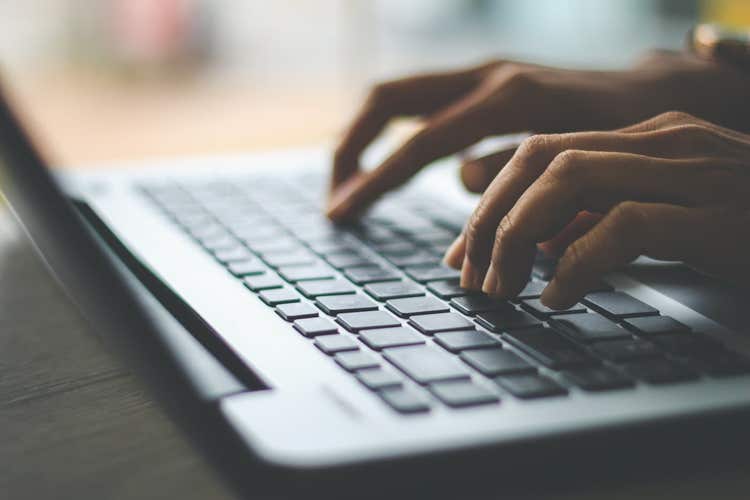 Hands typing on a keyboard