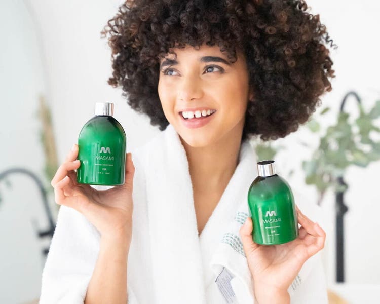 Woman holding two bottles of MASAMI product